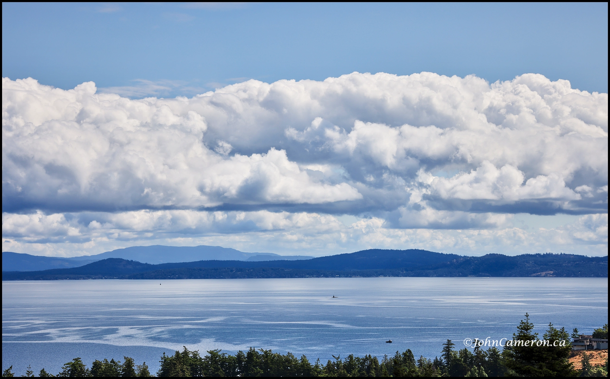 Blue sky and building clouds over Haro Strait ©johncameron.ca