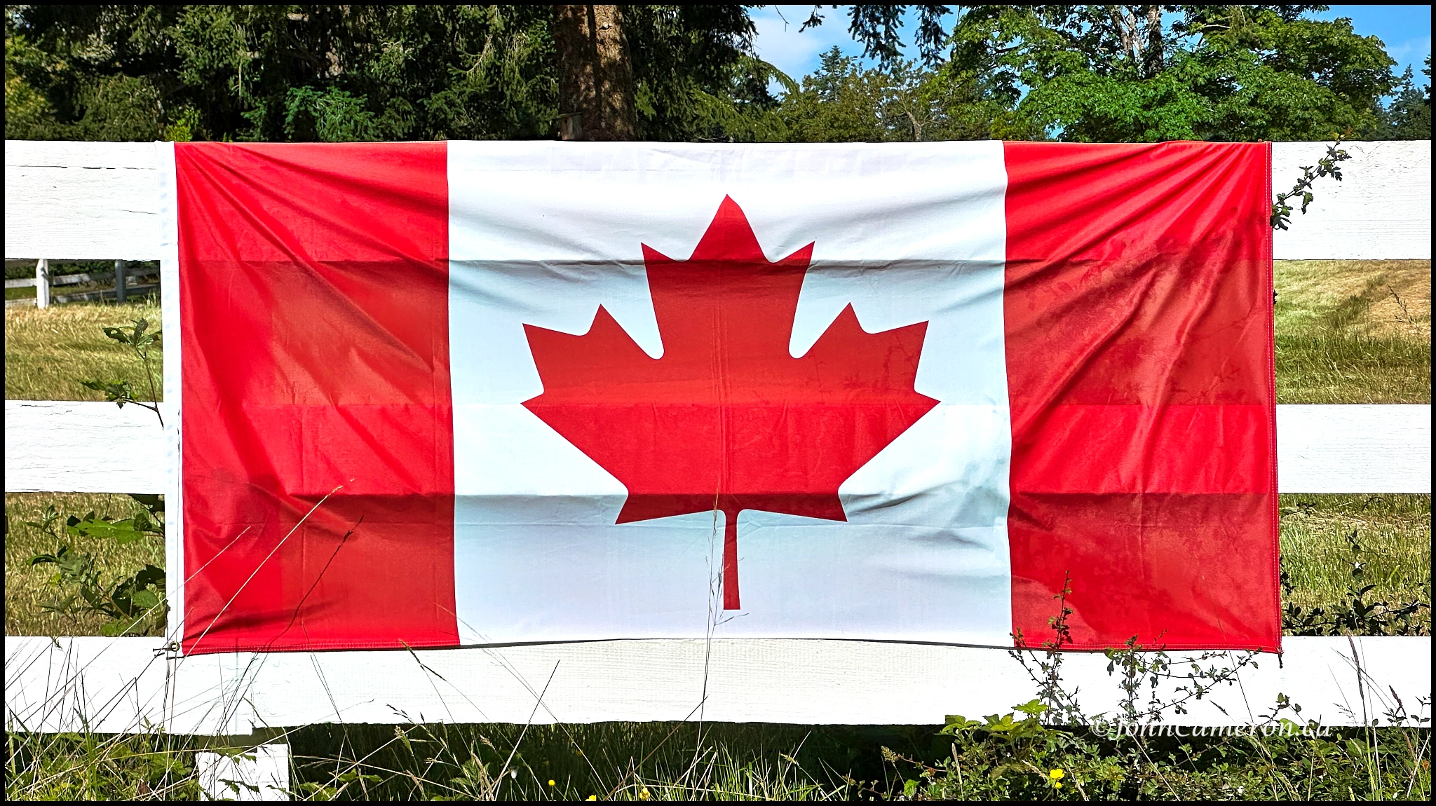 Canada flag on farm fence ©johncameron.ca